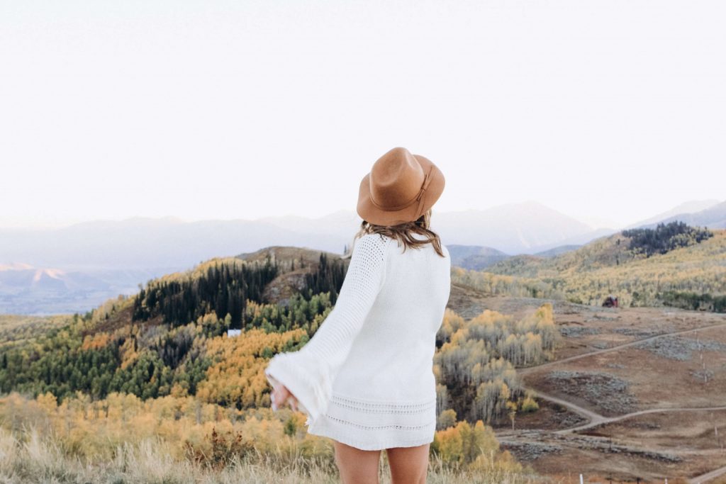 Young woman in white dress and hat